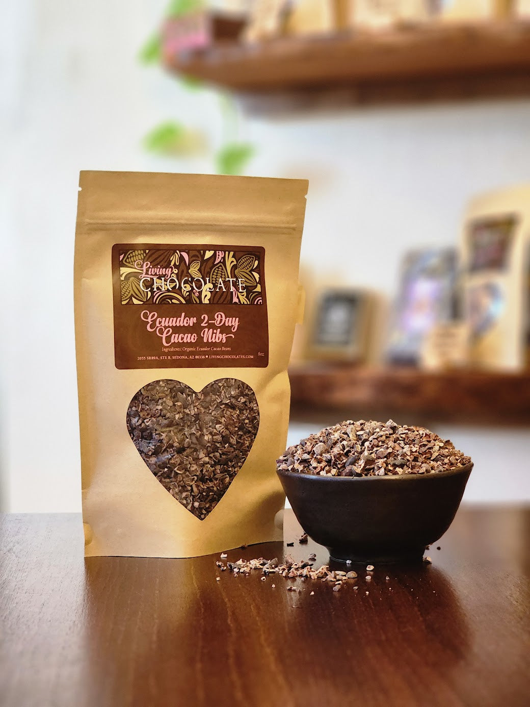 An 8 oz bag of Ecuador Cacao Nibs nexts to a bowl of nibs
