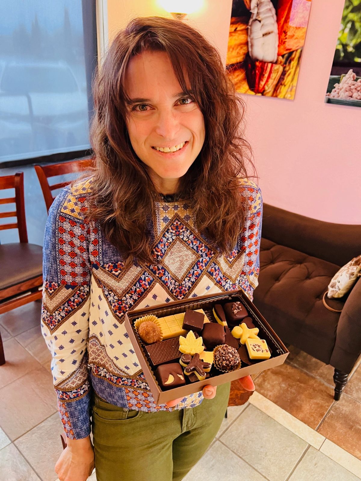 Image of Shari, Living Chocolates owner and operator, holding an assorted box of chocolates
