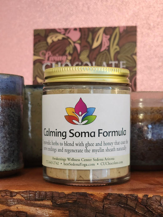 A 2 ounce jar of Calming Soma Formula sitting on a raw edge wooden shelf.