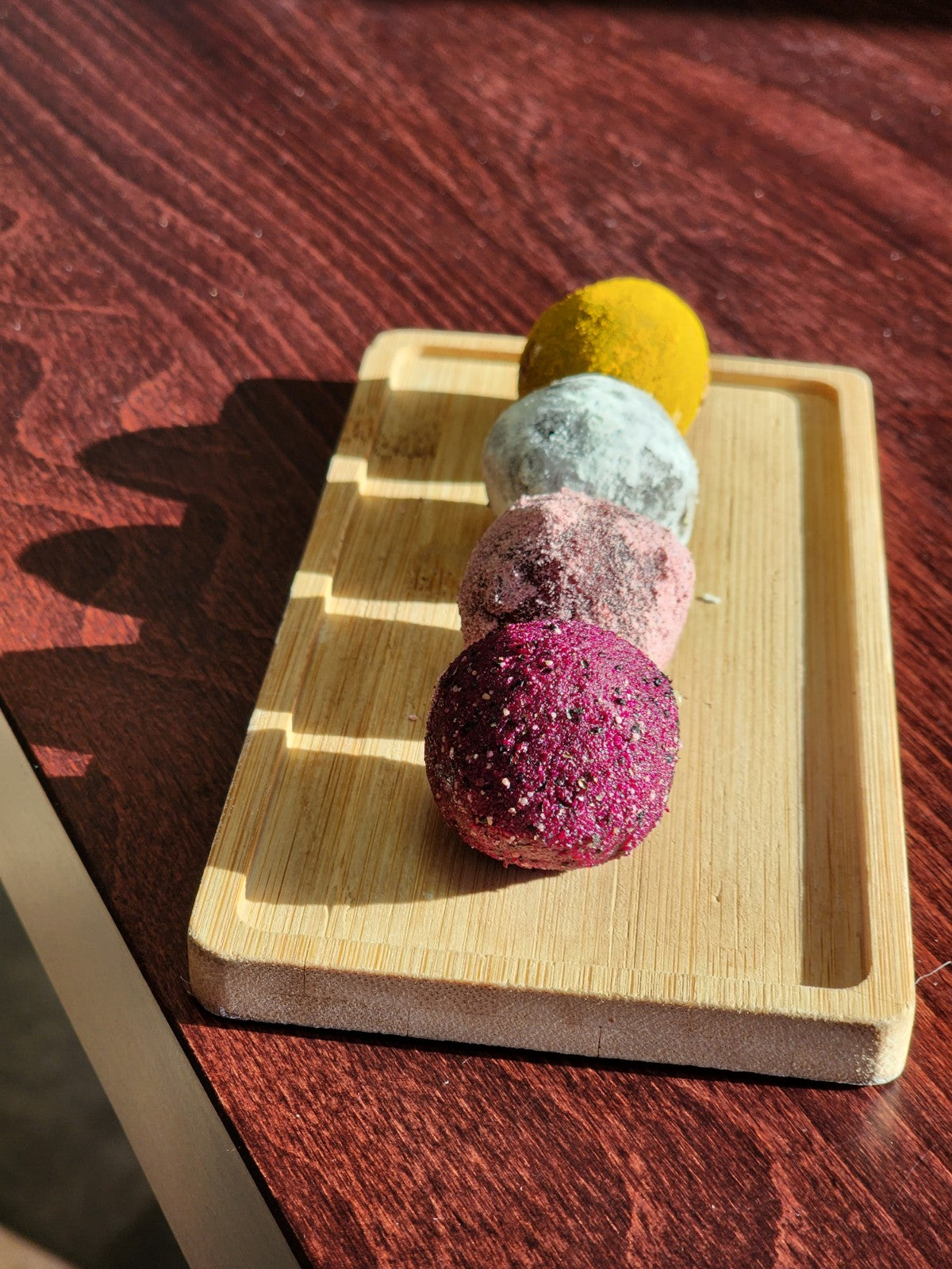 four colorful truffles in the sunlight