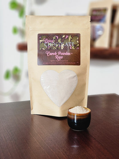 8 oz bag of Raw Carob Powder with small cup full of Raw carob Powder in front of bag