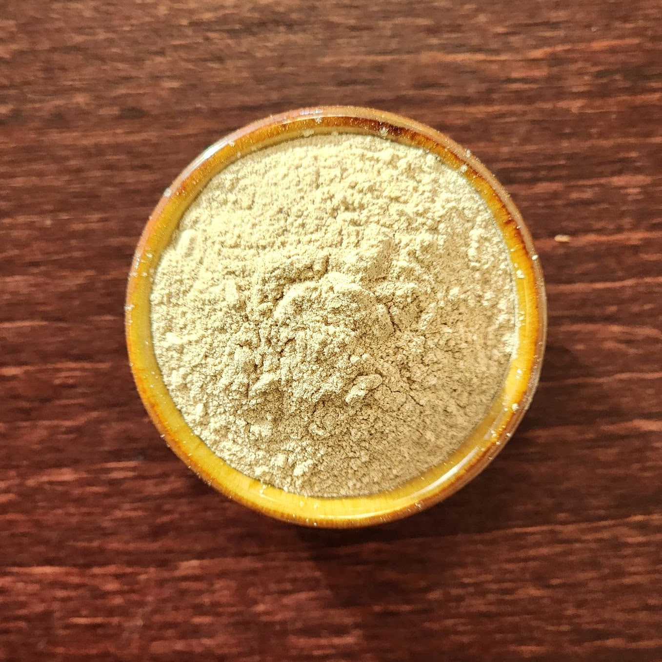 Top View of small cup of Raw Carob Powder