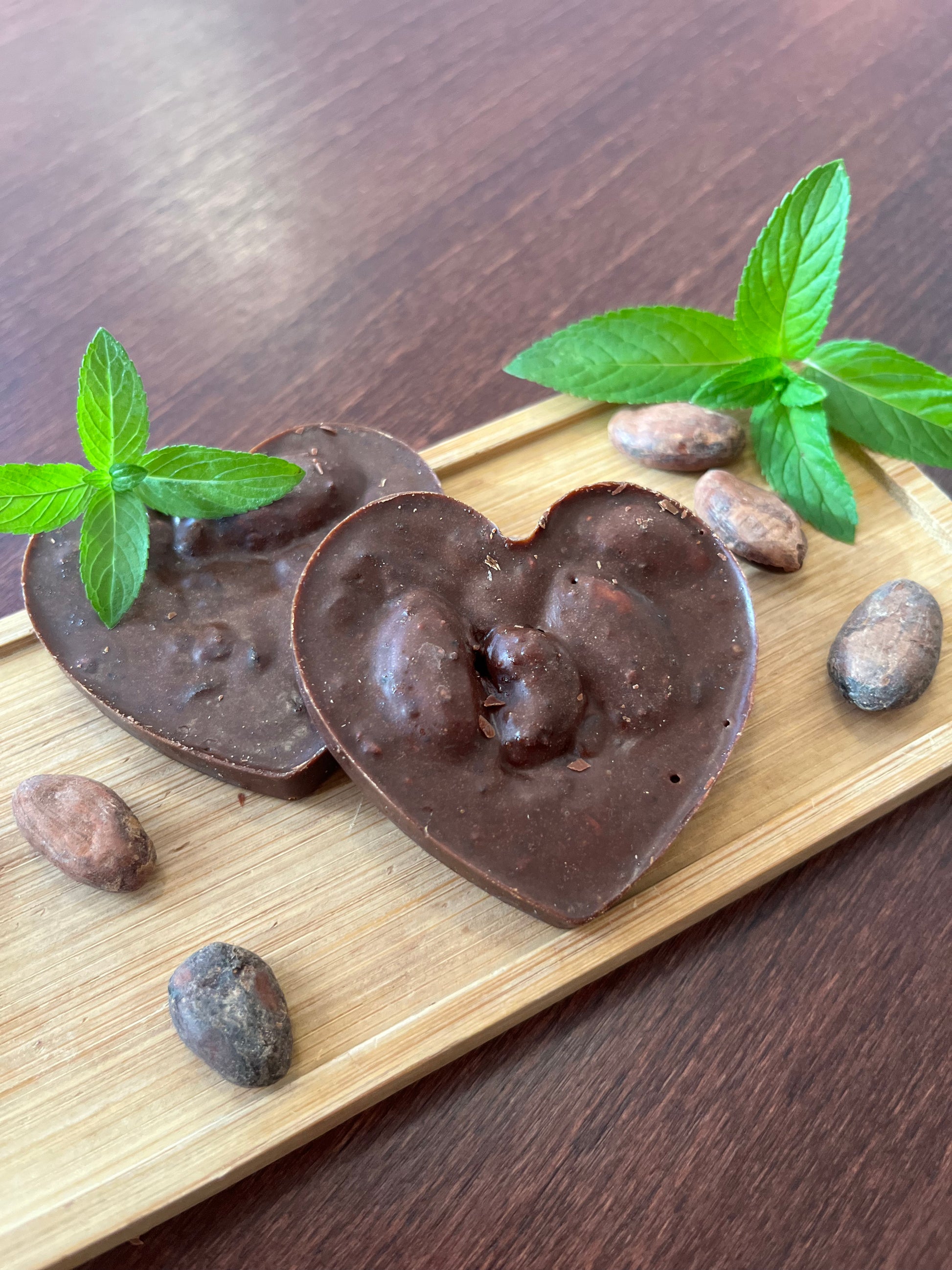 Whole Cacao Treats with cacao beans and fresh peppermint leaves