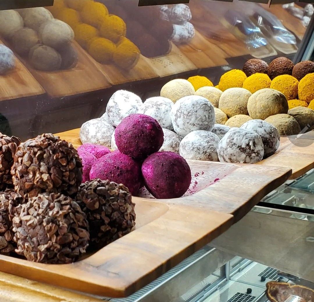 row of different flavored truffles in the shop display case